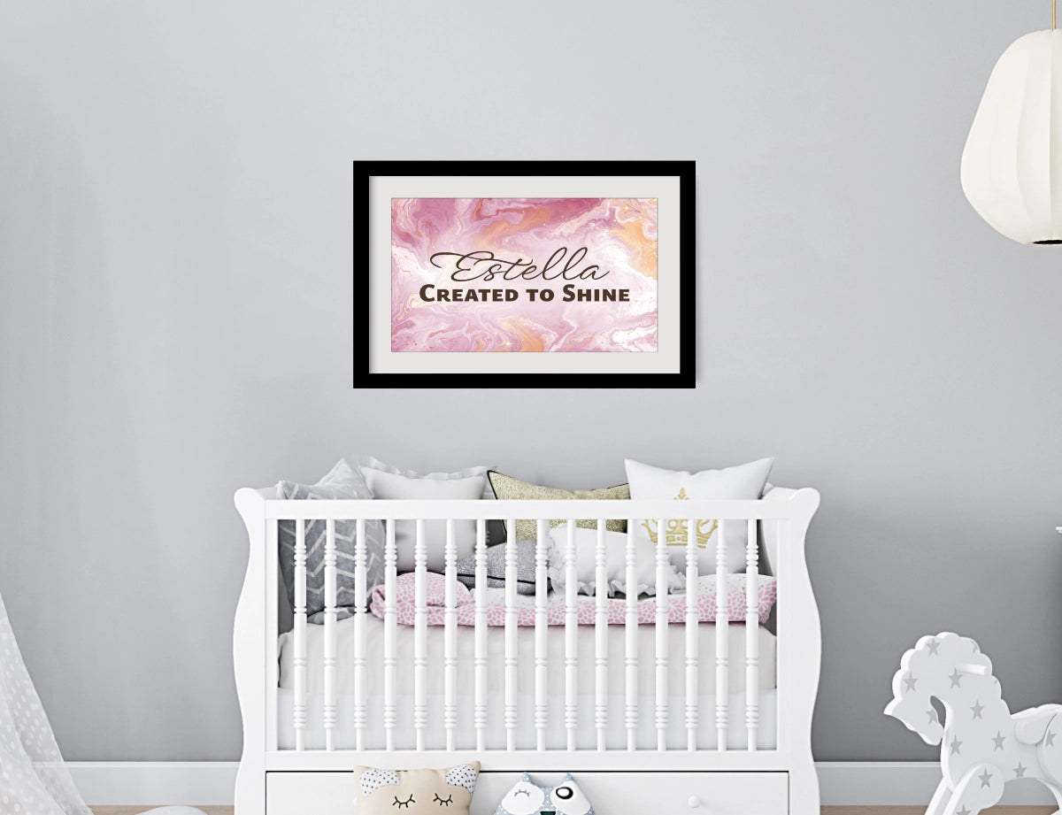 Personalized nursery room wall art printed with a white border, framed and displayed on a wall above a crib.