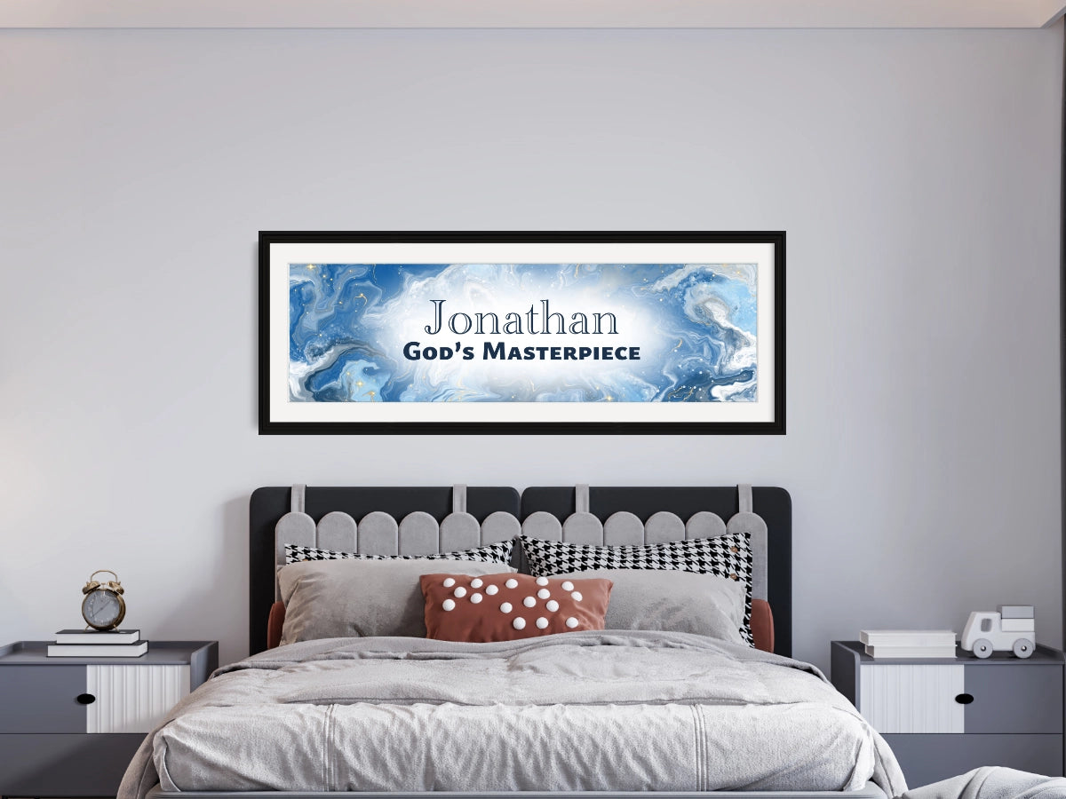 Personalized wall art with ‘Jonathan God’s Masterpiece' text in a child’s bedroom with gray bedding and two nightstands