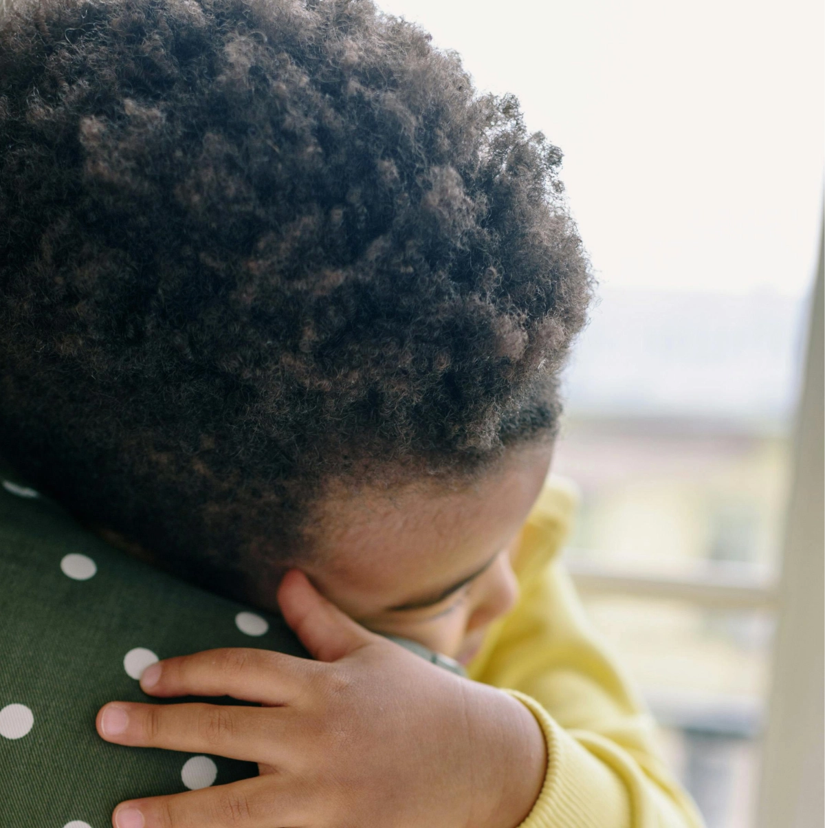 Close up of child hugging his mother