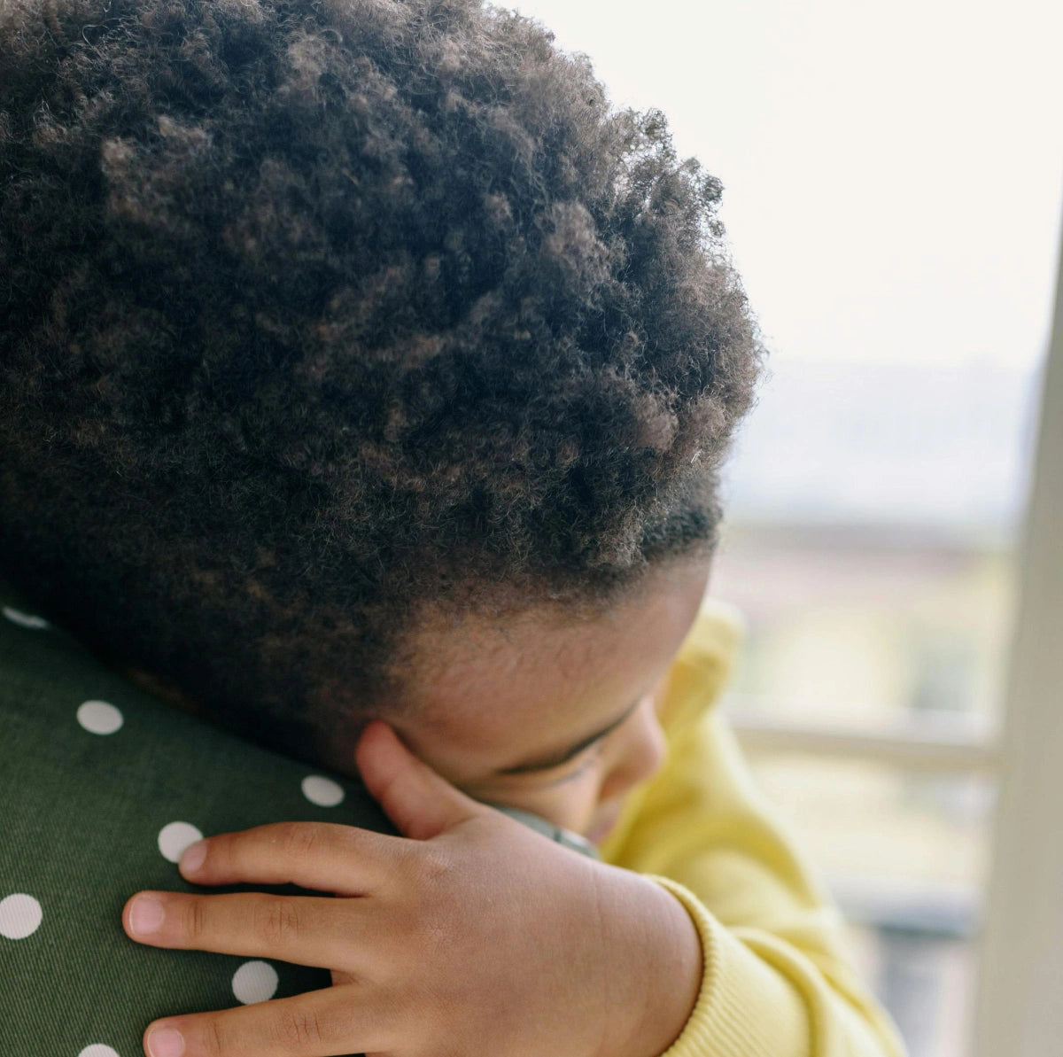 Close up of child hugging his mother