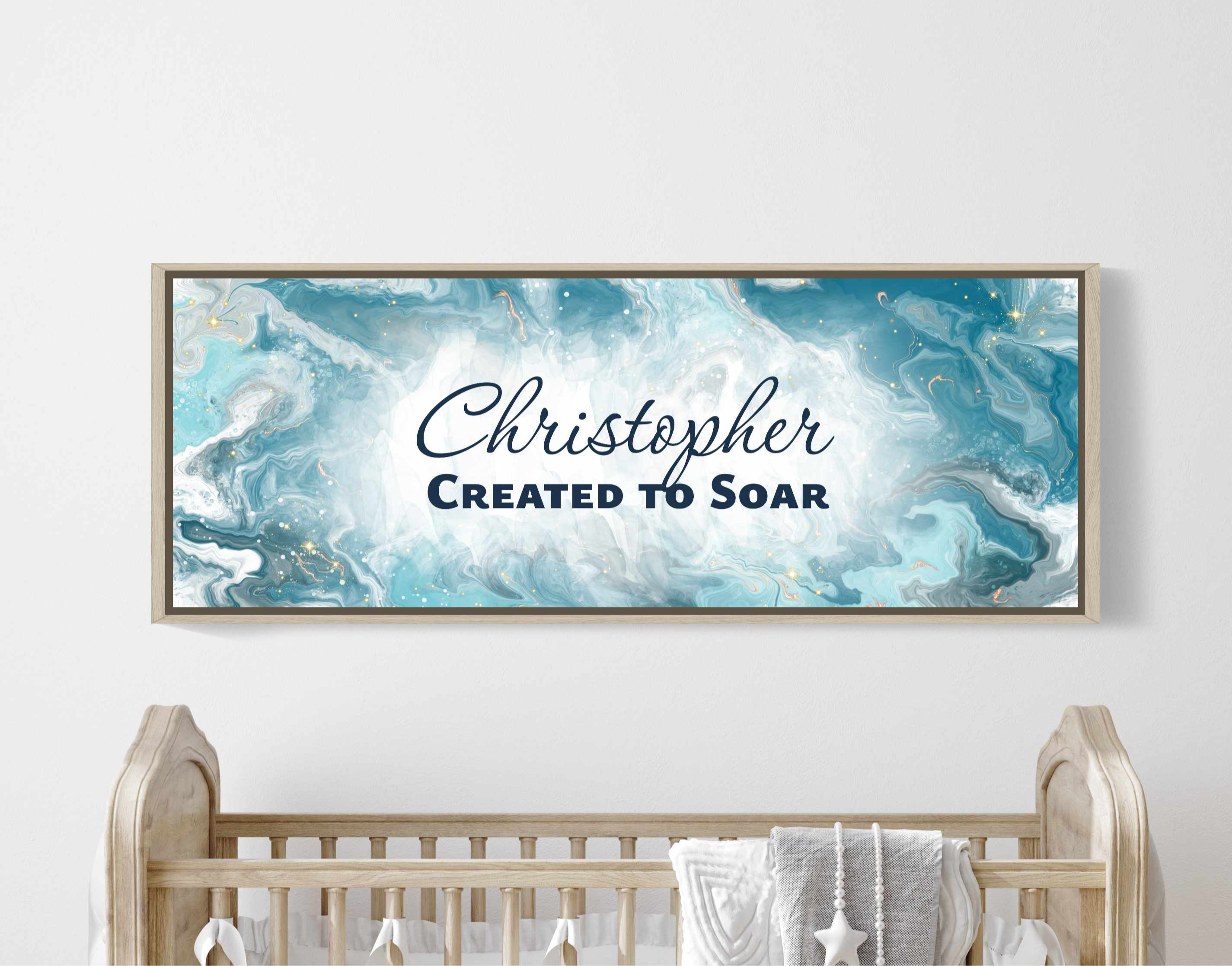 Framed, personalized wall art with ‘Christopher Created Soar' text above a crib in a nursery