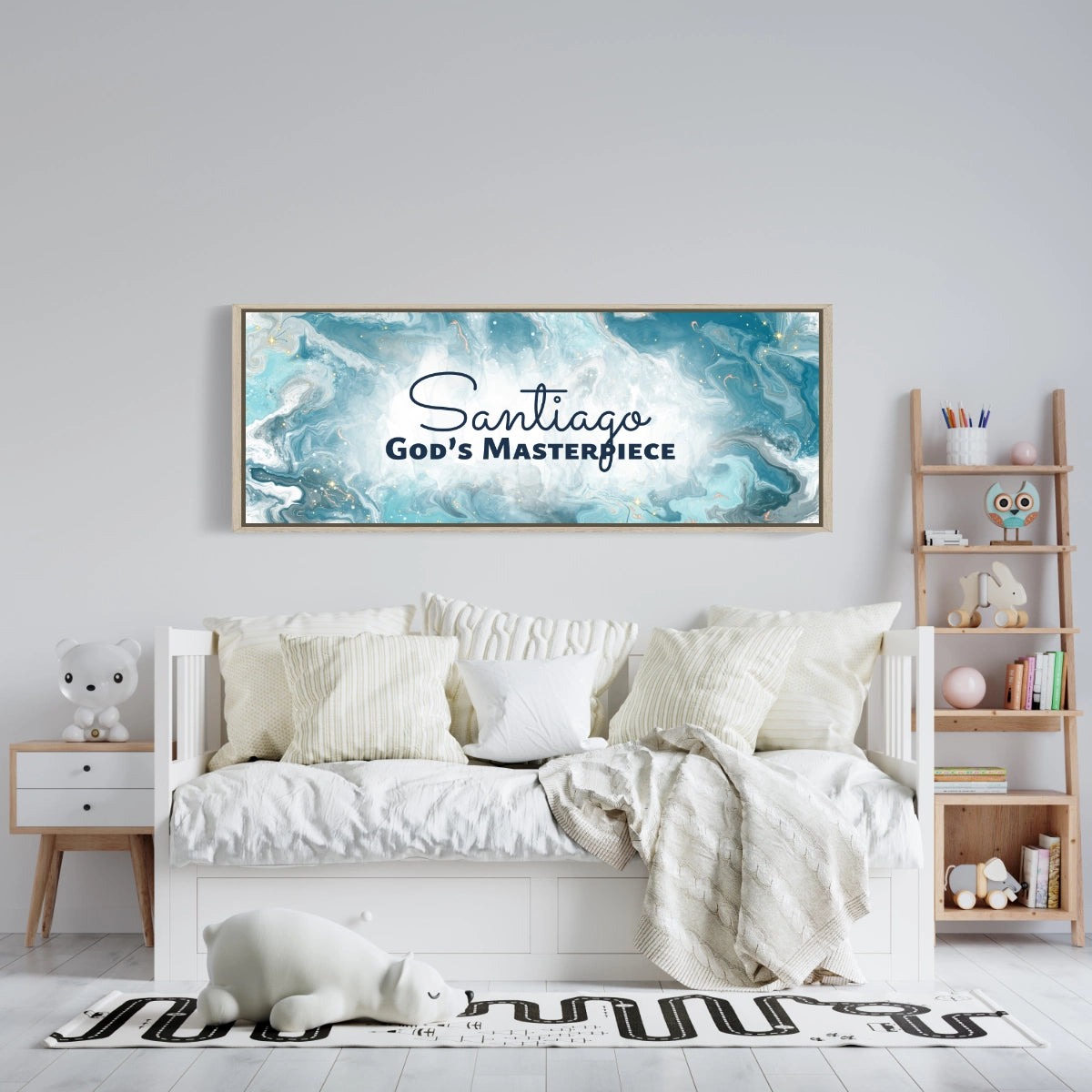 Framed, personalized wall art with ‘Santiago God’s Masterpiece' text above a white bed with white bedding in a child’s room