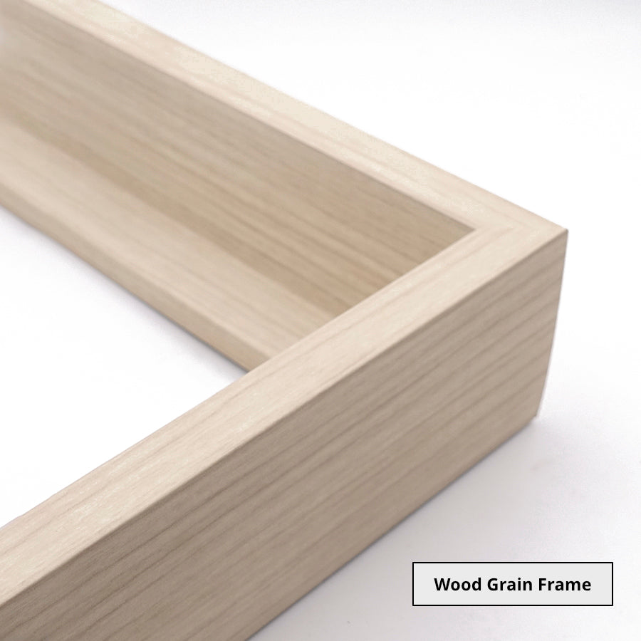 Close up of the corner of a light wooden picture frame on a white background