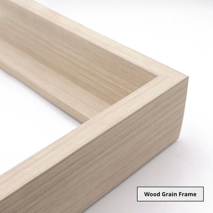 Close up of the corner of a light wooden picture frame on a white background